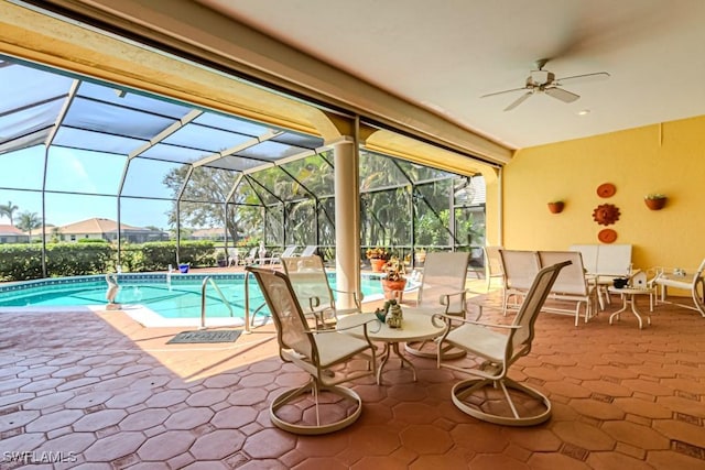 pool with a lanai, a patio, and ceiling fan