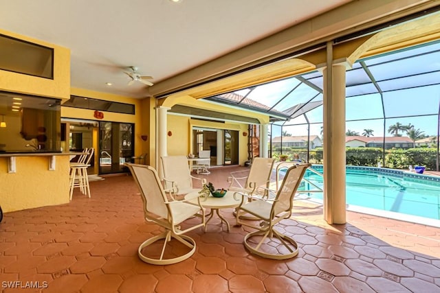 sunroom / solarium featuring ceiling fan and a pool