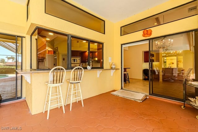 view of patio / terrace with outdoor dry bar and visible vents