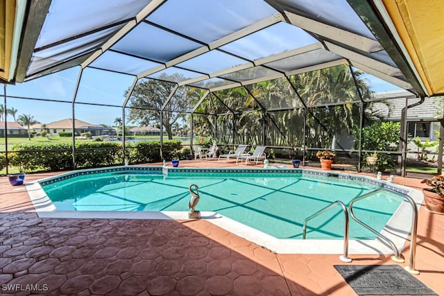 outdoor pool with glass enclosure and a patio