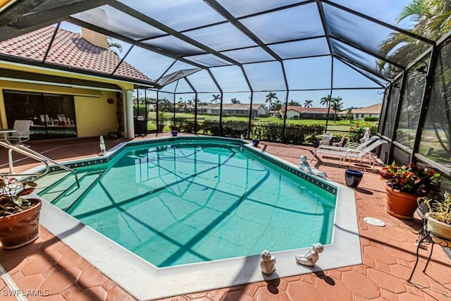 pool featuring a patio and glass enclosure