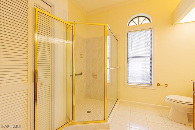 full bath featuring a stall shower, tile patterned floors, toilet, and crown molding