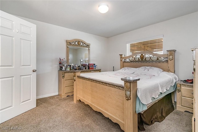 bedroom with light colored carpet and baseboards