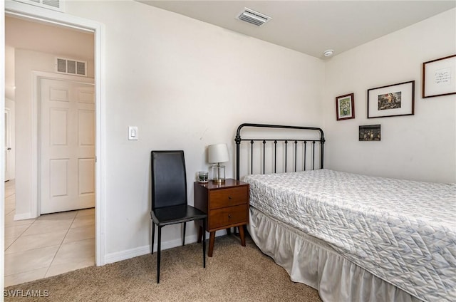 bedroom with light colored carpet, visible vents, baseboards, and light tile patterned flooring