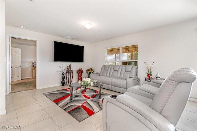 living area with light tile patterned floors and baseboards