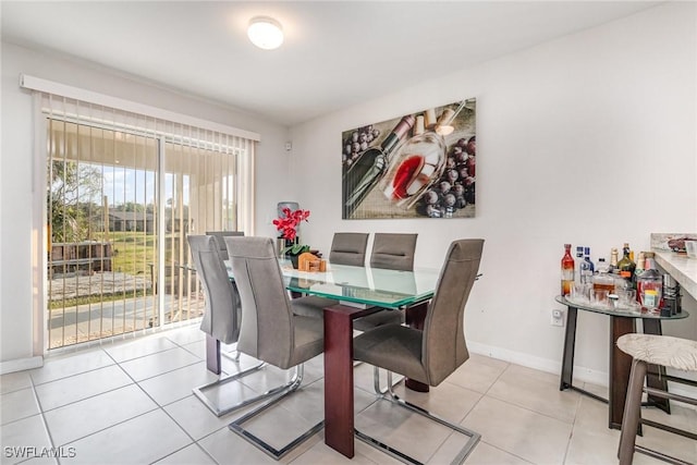 dining area featuring baseboards and light tile patterned floors