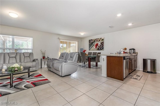 living room with visible vents and light tile patterned floors