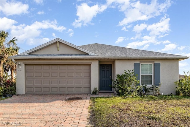 single story home featuring stucco siding, roof with shingles, an attached garage, decorative driveway, and a front yard