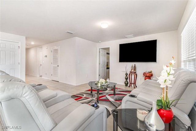 living area with visible vents, baseboards, and light tile patterned floors