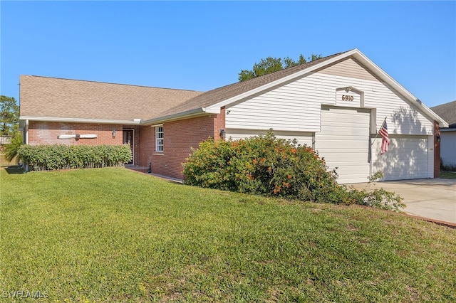 view of home's exterior with a yard, concrete driveway, brick siding, and a garage