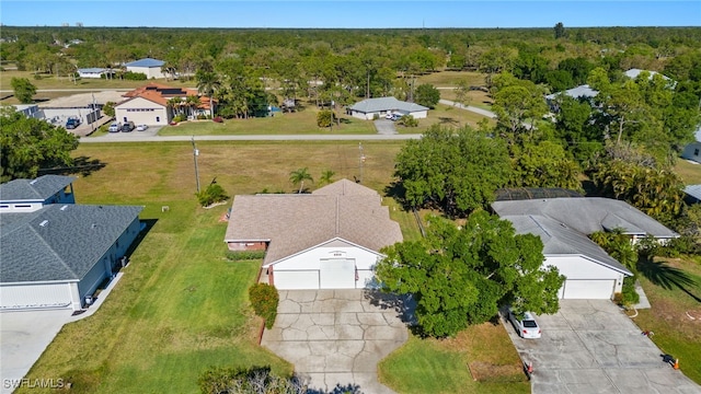 bird's eye view with a wooded view