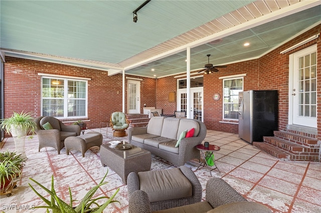 view of patio / terrace featuring an outdoor living space, french doors, ceiling fan, and entry steps