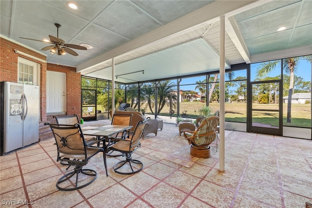 sunroom featuring ceiling fan