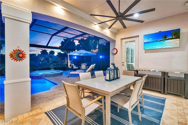 dining space featuring stone finish floor and a sunroom