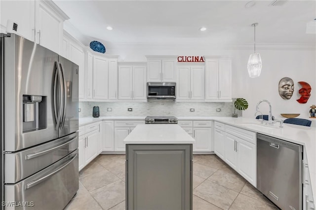 kitchen featuring white cabinets, a kitchen island, stainless steel appliances, light countertops, and a sink