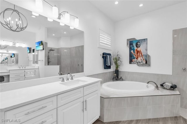 full bath featuring a walk in shower, wood finished floors, vanity, and a bath