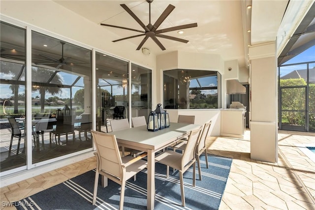 sunroom with ceiling fan with notable chandelier