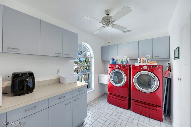 laundry area featuring visible vents, washing machine and dryer, cabinet space, and a ceiling fan