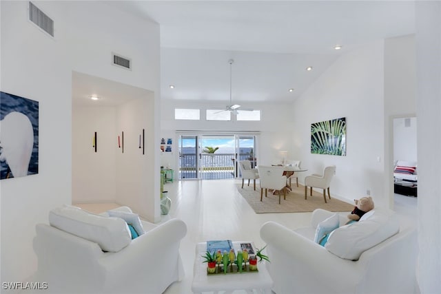 living room with high vaulted ceiling, visible vents, a ceiling fan, and recessed lighting