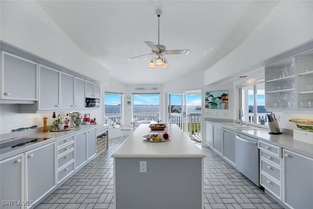 kitchen with dishwasher, a kitchen island, light countertops, white cabinetry, and open shelves