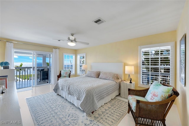 bedroom featuring ceiling fan, access to outside, wood finished floors, and visible vents