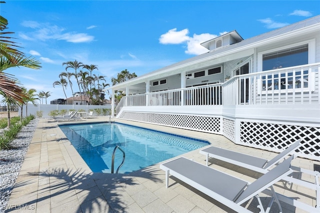 view of swimming pool featuring fence, a fenced in pool, and a patio