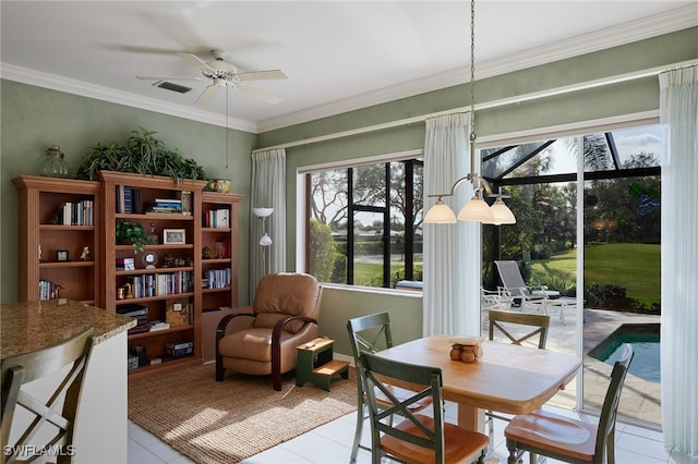 interior space featuring light tile patterned floors, a ceiling fan, visible vents, and crown molding