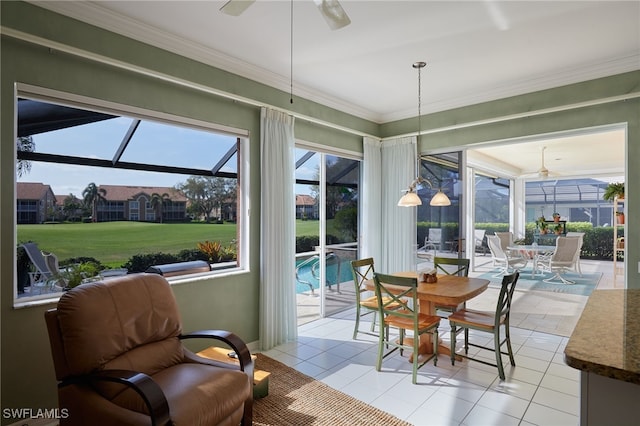 sunroom / solarium featuring a ceiling fan