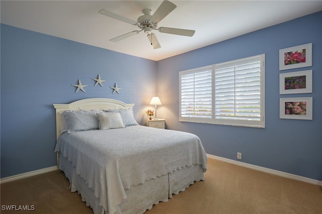 bedroom with carpet floors, ceiling fan, and baseboards