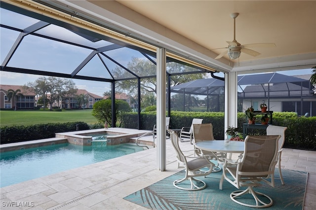 view of pool featuring a patio, glass enclosure, outdoor dining area, a pool with connected hot tub, and a residential view