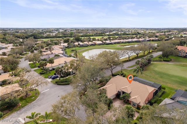 bird's eye view featuring golf course view, a water view, and a residential view