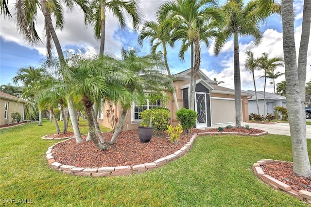 15773 Beachcomber Ave, Fort Myers, FL 33908 - view of front of property with a garage, concrete driveway, glass enclosure, stucco siding, and a front yard