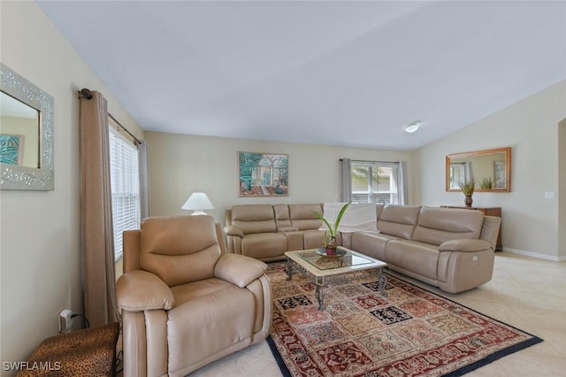 15773 Beachcomber Ave, Fort Myers, FL 33908 - living area with light tile patterned floors, baseboards, vaulted ceiling, and a wealth of natural light