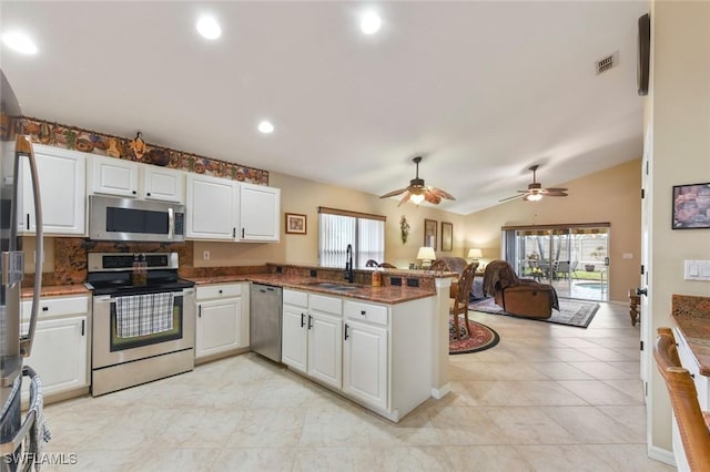 15773 Beachcomber Ave, Fort Myers, FL 33908 - kitchen with white cabinets, appliances with stainless steel finishes, open floor plan, a peninsula, and a sink