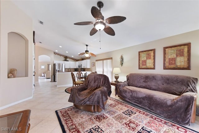 15773 Beachcomber Ave, Fort Myers, FL 33908 - living room featuring lofted ceiling, light tile patterned floors, arched walkways, visible vents, and baseboards
