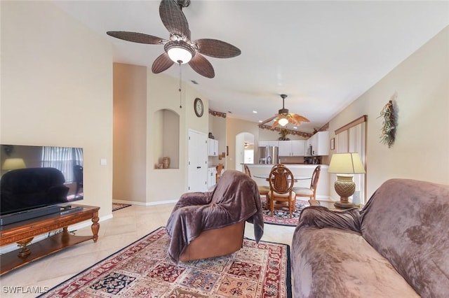 15773 Beachcomber Ave, Fort Myers, FL 33908 - living room featuring light tile patterned floors, baseboards, arched walkways, lofted ceiling, and ceiling fan