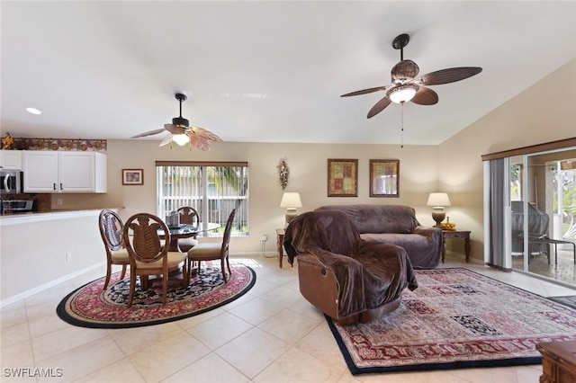 15773 Beachcomber Ave, Fort Myers, FL 33908 - living room with light tile patterned flooring, vaulted ceiling, baseboards, and ceiling fan