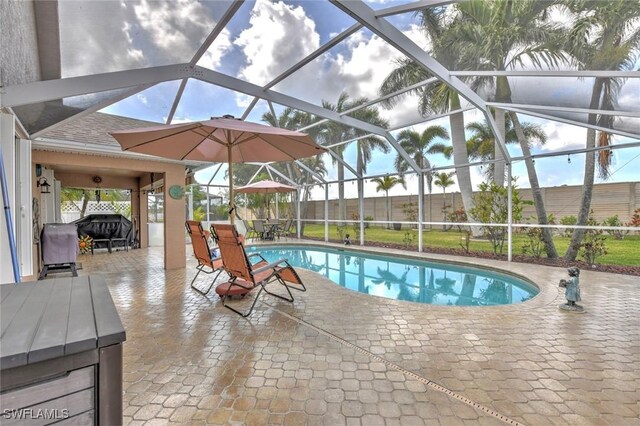 15773 Beachcomber Ave, Fort Myers, FL 33908 - view of swimming pool featuring glass enclosure, a fenced backyard, grilling area, a fenced in pool, and a patio area