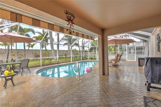 15773 Beachcomber Ave, Fort Myers, FL 33908 - view of swimming pool featuring a fenced in pool, glass enclosure, and a patio area