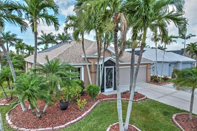 15773 Beachcomber Ave, Fort Myers, FL 33908 - ranch-style home featuring a garage, concrete driveway, roof with shingles, stucco siding, and a front lawn