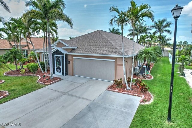 15773 Beachcomber Ave, Fort Myers, FL 33908 - single story home featuring stucco siding, a shingled roof, concrete driveway, a garage, and a front lawn