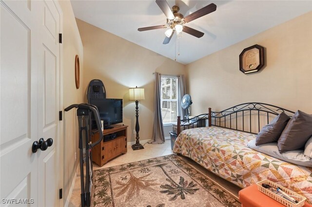 15773 Beachcomber Ave, Fort Myers, FL 33908 - bedroom with a ceiling fan, vaulted ceiling, baseboards, and light tile patterned floors