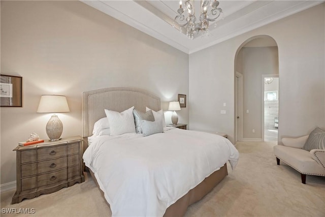 carpeted bedroom featuring arched walkways, a tray ceiling, a chandelier, and baseboards