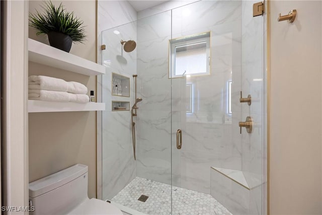 bathroom with toilet and a marble finish shower