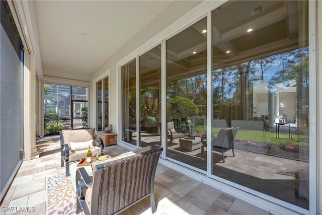 sunroom / solarium featuring visible vents and coffered ceiling