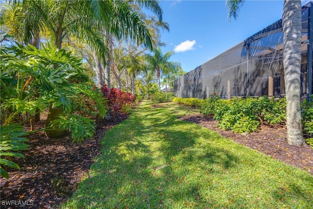 view of yard featuring glass enclosure