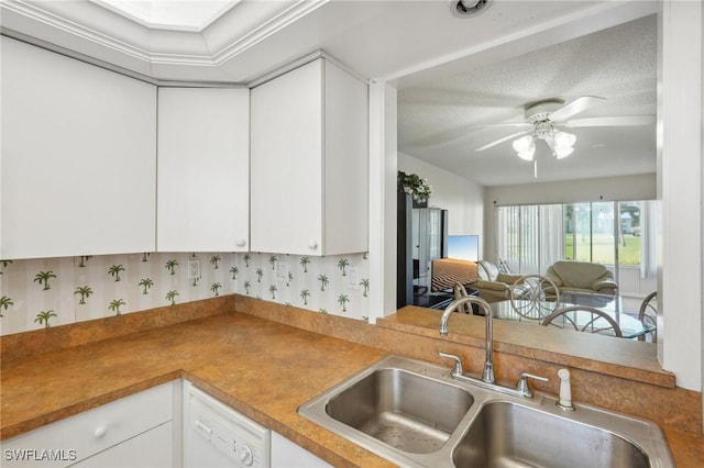 kitchen featuring white cabinets, dishwasher, ceiling fan, open floor plan, and a sink