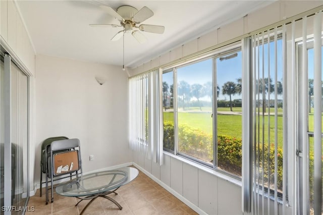 sunroom featuring a ceiling fan