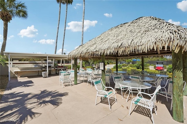 view of patio featuring a gazebo and outdoor dining space