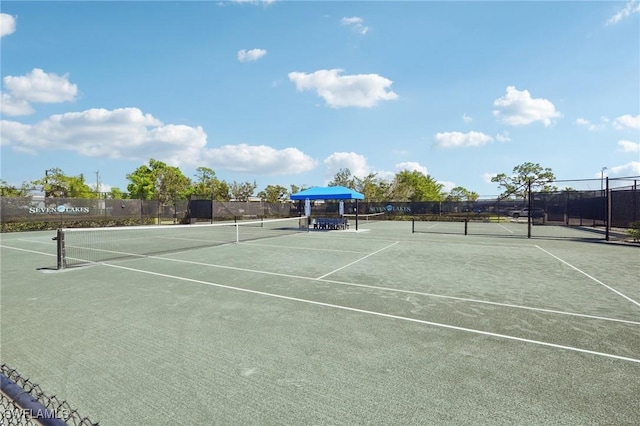 view of tennis court featuring fence